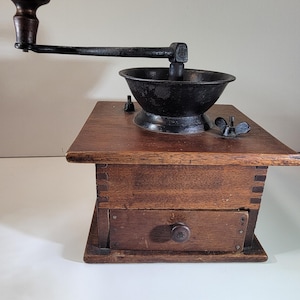 Antique coffee grinder, cast iron top, wood box base, display item