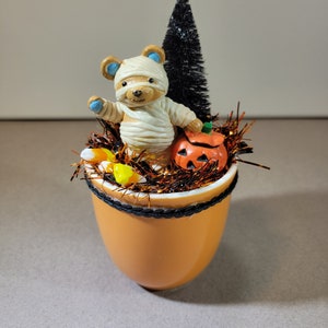 Handcrafted Halloween Miniature Vignette with vintage trick or treating mummy bear, pumpkin, and bottle brush trees