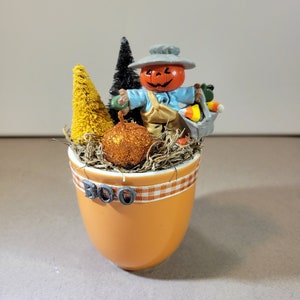 Viñeta en miniatura de Halloween hecha a mano con espantapájaros antiguos, calabazas y árboles hechos con cepillos para botellas