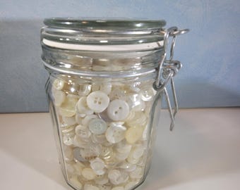 Vintage glass canning jar filled with Mother of Pearl and white buttons, crafting or display