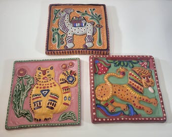 3 Mexican Folk art clay wall plaques featuring stylized animals, cat, tiger, camel