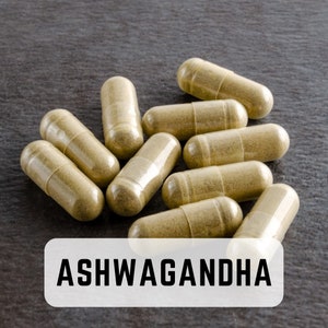 May include: A close-up of a pile of beige capsules labeled "ASHWAGANDHA".