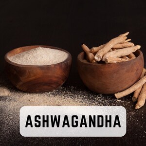 May include: Two wooden bowls, one filled with light brown powder and the other with dried brown roots. The text "ASHWAGANDHA" is printed in white on a gray rectangle below the bowls.
