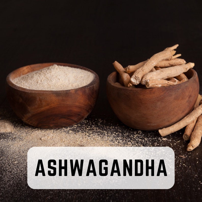 May include: Two wooden bowls, one filled with light brown powder and the other with dried brown roots. The text "ASHWAGANDHA" is printed in white on a gray rectangle below the bowls.