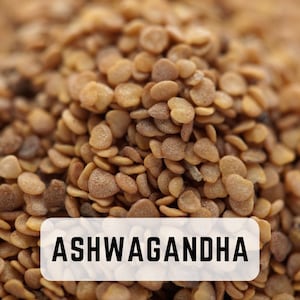May include: Close-up of a pile of light brown ashwagandha seeds. The seeds are small and round, with a slightly rough texture. The text "ASHWAGANDHA" is printed in black on a white rectangle.