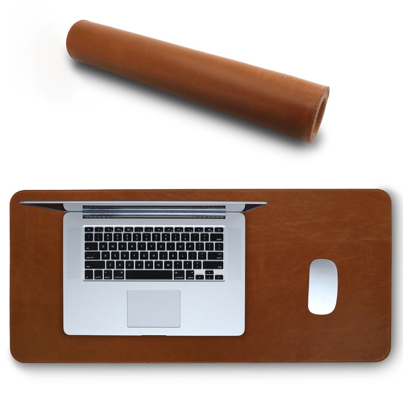 May include: A brown leather desk mat with a laptop and a white mouse on top. The mat is rolled up in the top left corner of the image.