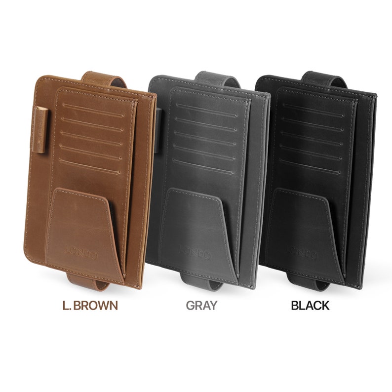 May include: Three car visor organizers in different colors: light brown, gray, and black. Each organizer has multiple card slots, a pocket, and a strap.