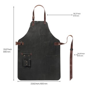 May include: Black leather apron with brown leather straps and buckles. It has two pockets and a tool loop. The apron measures 840 mm tall, 600 mm wide, and has a 875 mm strap.