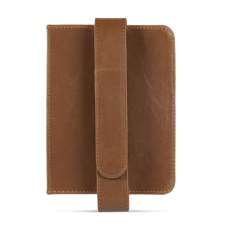 May include: A brown leather case with a strap for holding a tablet or e-reader.