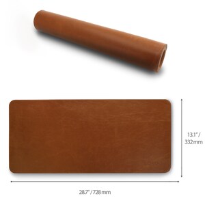 May include: A brown leather desk mat rolled up. The mat is 28.7 inches by 13.1 inches and has the word "LONDO" printed on it.
