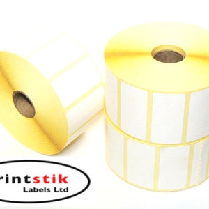 May include: Two rolls of white adhesive labels with yellow cores. The labels are in a grid pattern and are ideal for shipping, product labelling, or other uses.