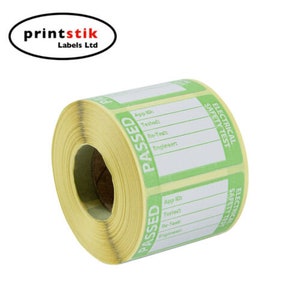 May include: A roll of yellow and green electrical safety test labels with the word "PASSED" printed in large green letters. The labels have spaces for App ID, Tested, Re-Test, and Engineer.