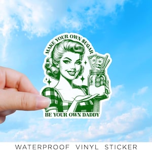 May include: A green and white vinyl sticker featuring a retro-style illustration of a person with curled hair wearing a checkered top. The person holds a glass jar filled with paper money and coins. Text reads: MAKE YOUR OWN SUGAR BE YOUR OWN DADDY.