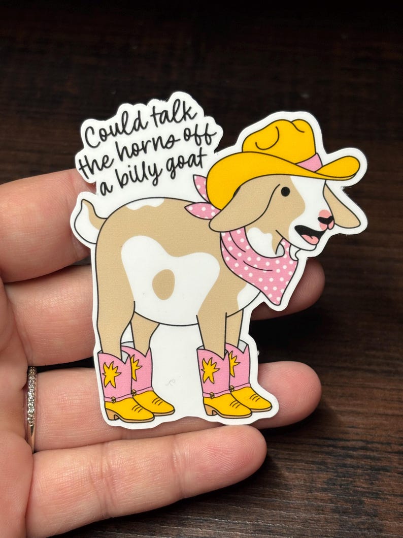 May include: A sticker depicting a cartoon goat in a yellow cowboy hat, pink polka-dot bandana, and pink cowboy boots with yellow details. The sticker includes the text "Could talk the horns off a billy goat."