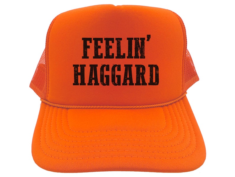 May include: Orange trucker hat with black text that reads "FEELIN' HAGGARD".