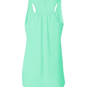 May include: A light green sleeveless tank top with a scoop neck and a racerback.
