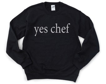May include: Black sweatshirt with the text "yes chef" printed in white on the front.