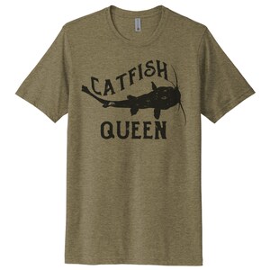 May include: A green t-shirt with a black catfish graphic and the text "Catfish Queen".