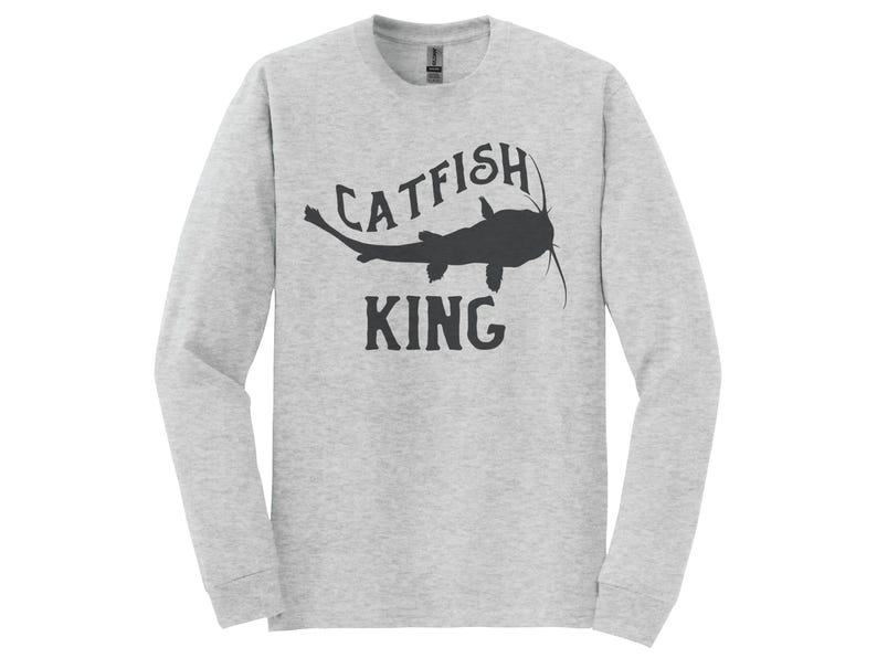 May include: A gray long-sleeve t-shirt with a black silhouette of a catfish and the text "CATFISH KING".