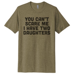 May include: A green heather t-shirt with the text "You can't scare me I have two daughters" printed in black.
