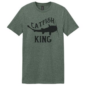 May include: A green t-shirt with a black catfish silhouette and the text "Catfish King" printed on the front.