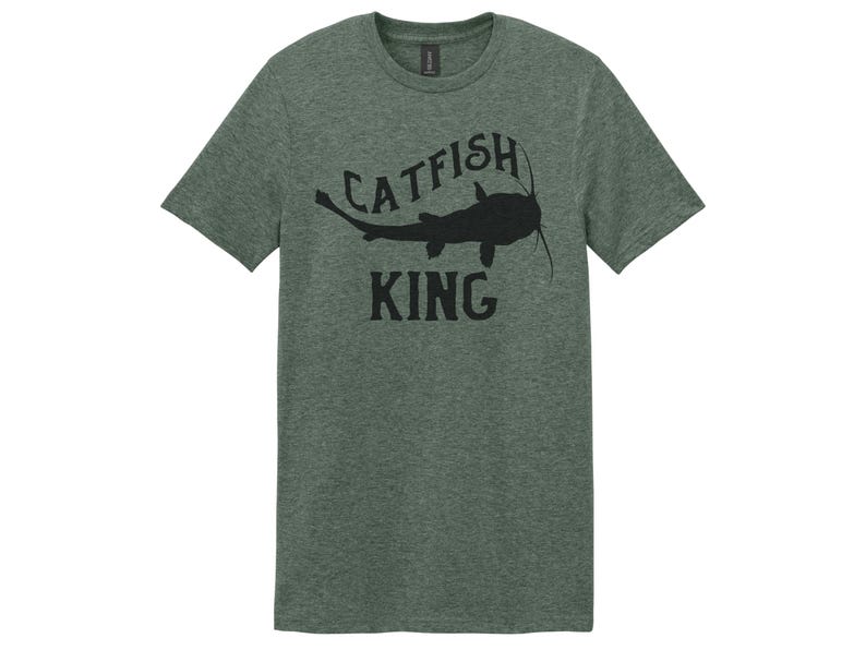 May include: A green t-shirt with a black catfish silhouette and the text "Catfish King" printed on the front.