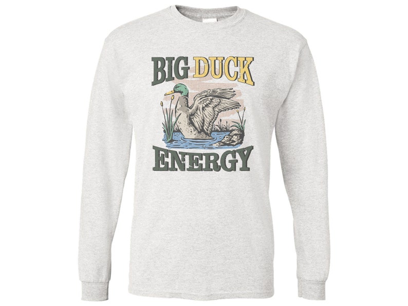 May include: A gray long-sleeve t-shirt with a vintage-style graphic of a duck in a pond. The text "BIG DUCK ENERGY" is printed in yellow and green letters.