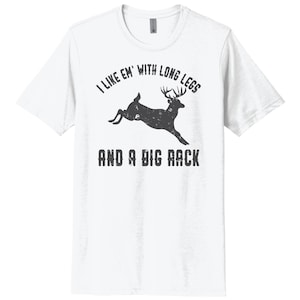 May include: White t-shirt with a black silhouette of a deer jumping with the text "I like 'em with long legs and a big rack".