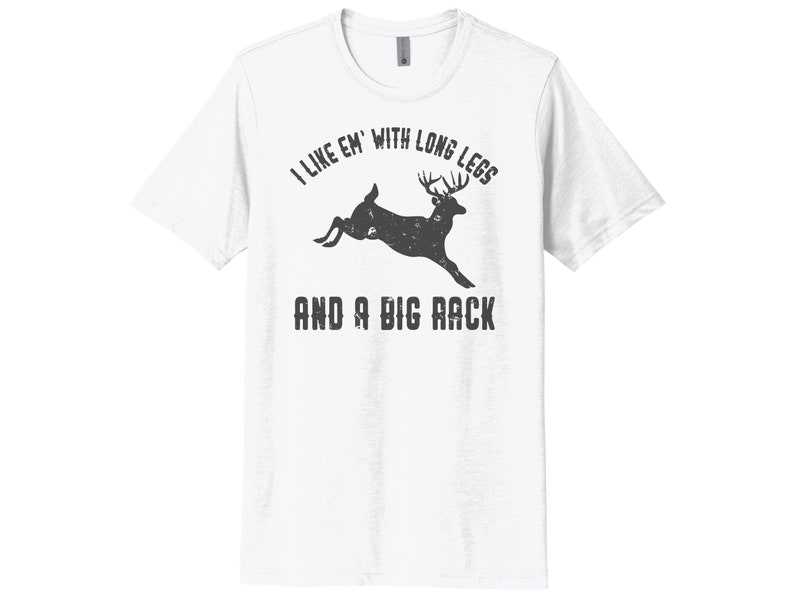 May include: White t-shirt with a black silhouette of a deer jumping with the text "I like 'em with long legs and a big rack".