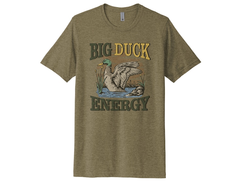 May include: A green, brown, and yellow t-shirt with a cartoon duck and the text "BIG DUCK ENERGY".