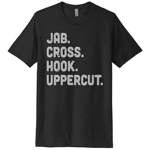 May include: Black t-shirt with white text that reads "JAB. CROSS. HOOK. UPPERCUT."