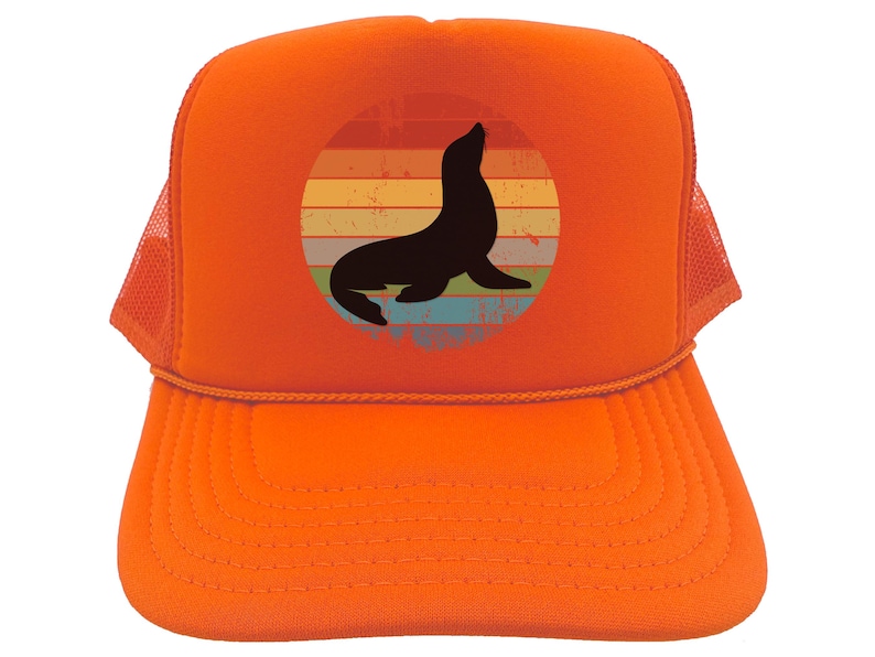 May include: Orange trucker hat with a vintage-style graphic of a seal in front of a sunset. The seal is black and the sunset is a rainbow of colors.