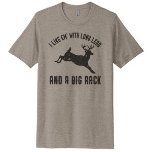 May include: A heather grey t-shirt with a black silhouette of a deer with large antlers and the text "I like 'em with long legs and a big rack".