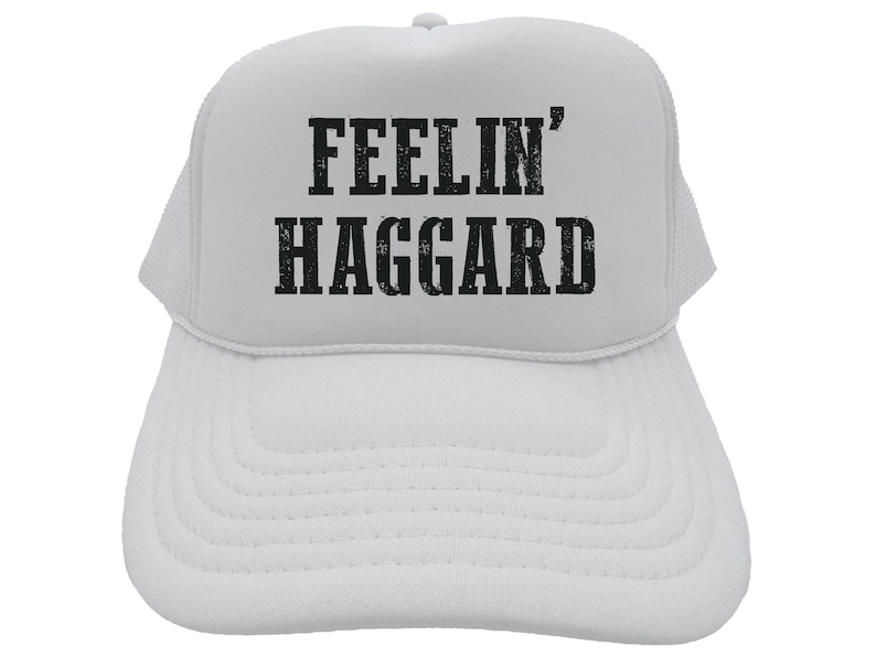 May include: White trucker hat with black text that reads "Feelin' Haggard".