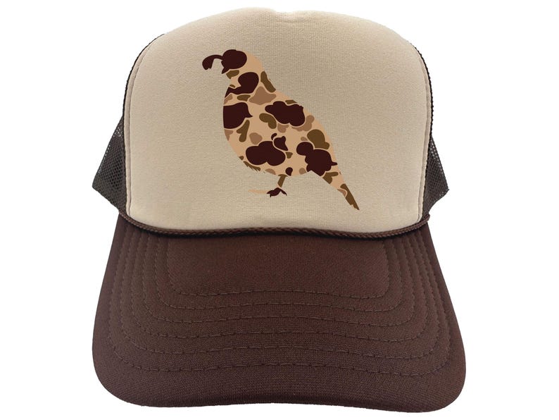 May include: A brown and beige trucker hat with a camouflage quail design on the front. The hat has a brown mesh back.