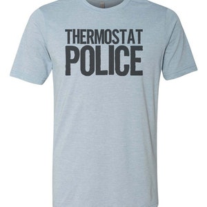 May include: A light blue t-shirt with the text "Thermostat Police" printed in black.
