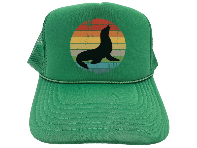 May include: A green trucker hat with a vintage-style graphic of a seal in a sunset. The seal is black and the sunset is in shades of orange, yellow, and red.