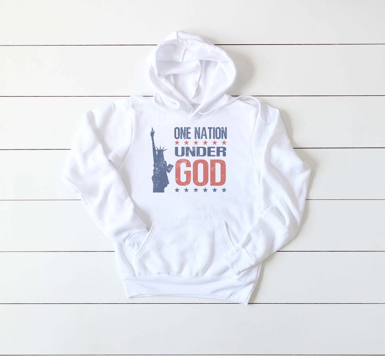 May include: White hoodie with a blue and red graphic of the Statue of Liberty and the text "ONE NATION UNDER GOD" with stars.