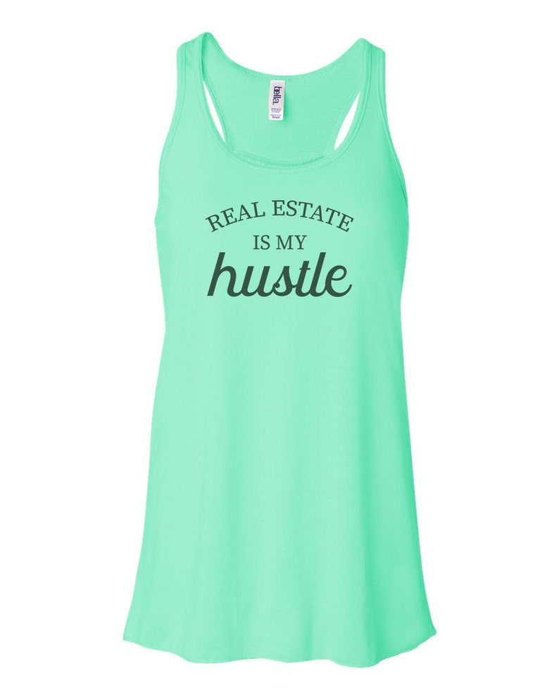 May include: A light green tank top with the text "Real Estate is my hustle" in black.