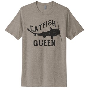May include: A heather grey t-shirt with a black graphic of a catfish and the text "Catfish Queen".