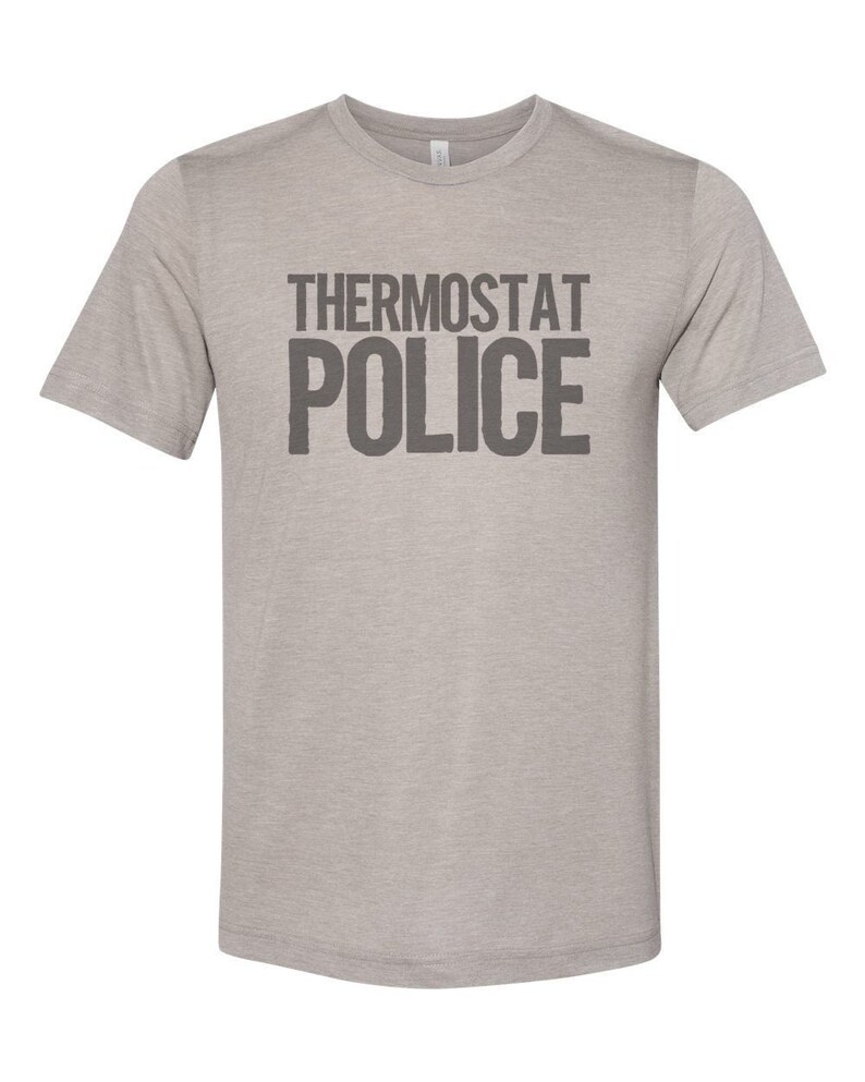May include: A heather grey t-shirt with the text "THERMOSTAT POLICE" printed in black.