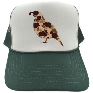 May include: A white and green trucker hat with a camouflage quail design. The quail is brown, tan, and black.