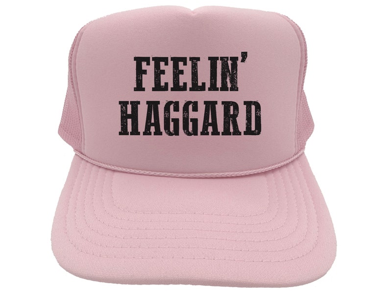 May include: A pink trucker hat with black text that reads "Feelin' Haggard".