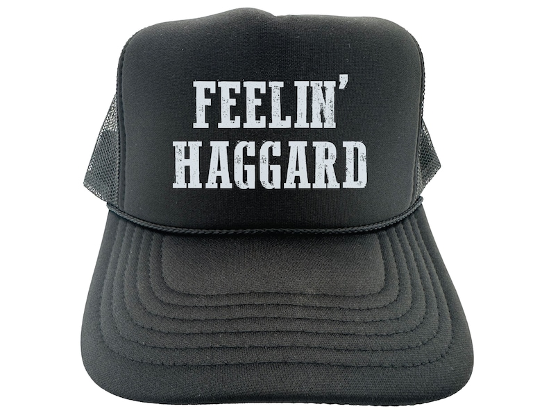 May include: Black trucker hat with a white mesh back. The front of the hat has white text that reads "FEELIN' HAGGARD".