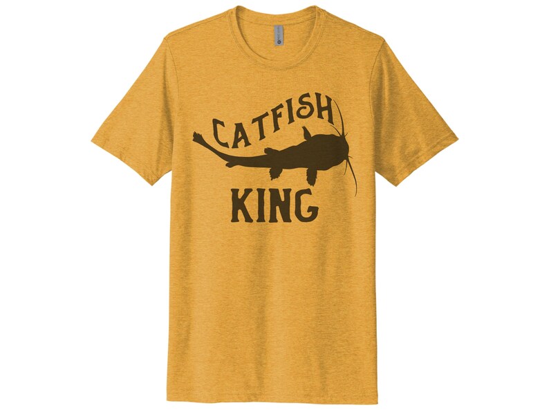 May include: A yellow t-shirt with a brown catfish silhouette and the text "CATFISH KING" printed on the front.