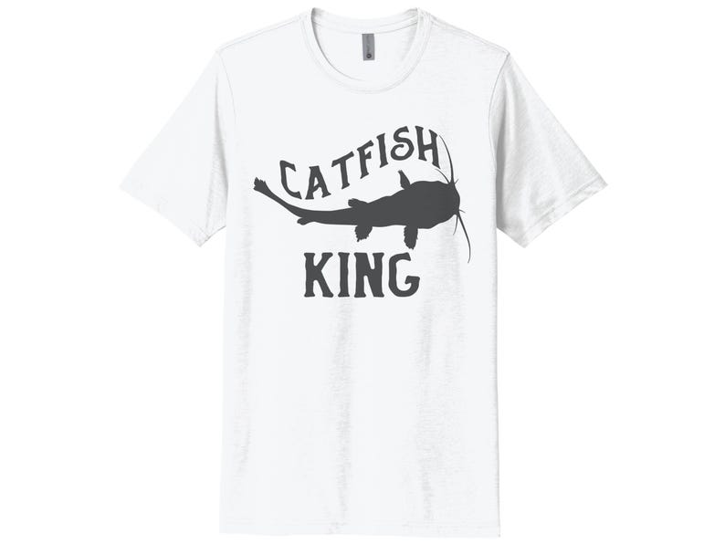 May include: White t-shirt with a black silhouette of a catfish and the text "CATFISH KING" printed on the front.