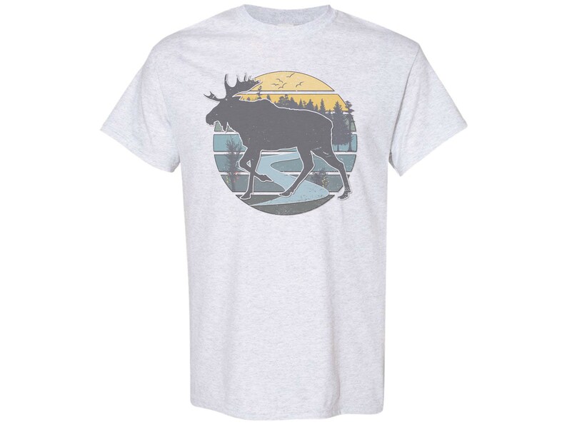 May include: A gray t-shirt with a vintage-style graphic of a moose walking through a forest with a sunset in the background.