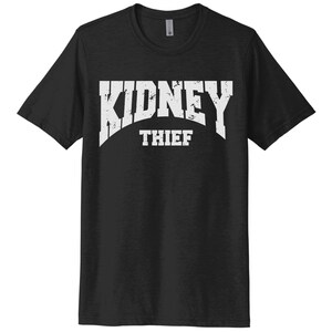 May include: Black t-shirt with white text that reads "KIDNEY THIEF" in a distressed font.