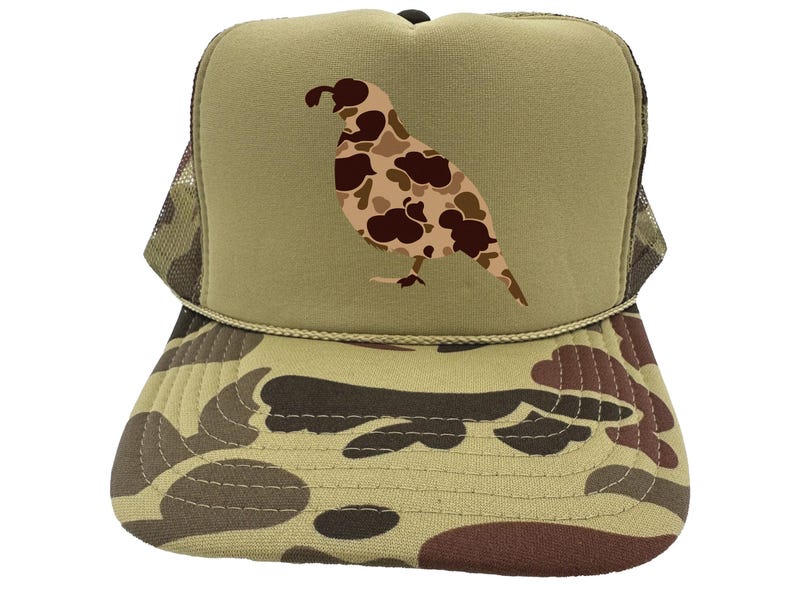 May include: A camouflage trucker hat with a brown and tan camouflage pattern. The front of the hat features a brown and tan camouflage quail silhouette.