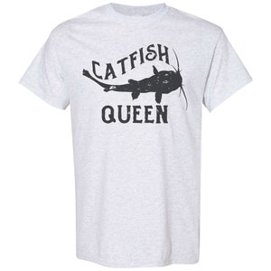 May include: A light grey t-shirt with a black catfish graphic and the text "CATFISH QUEEN".